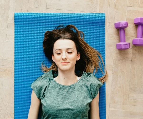 A serene and tidy corner of a room with a yoga mat.