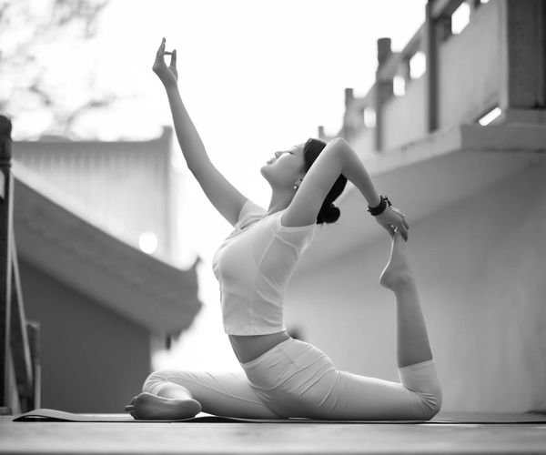 Person meditating peacefully in a natural outdoor setting.